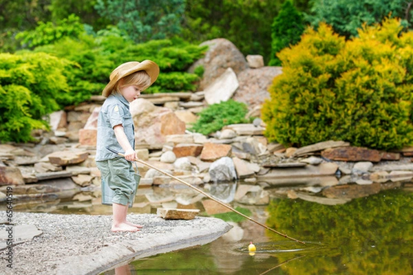 Obraz Cute child fishing by the pond in the beautiful garden
