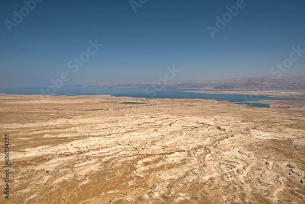Obraz From Masada, Israel, gaze eastward to a breathtaking vista. The vast desert sprawls beneath, and the shimmering Dead Sea, nature's mirror, glimmers in the distance, creating a mesmerizing panorama.