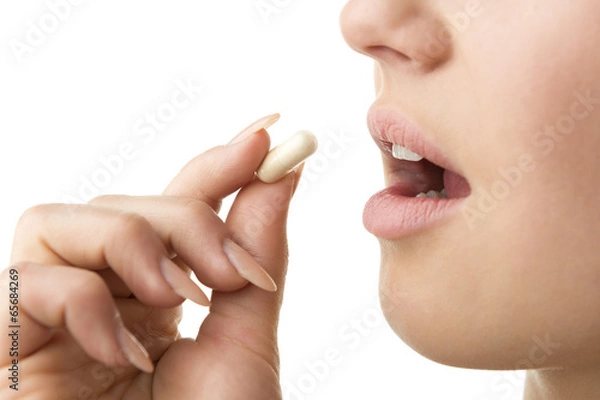 Fototapeta closeup taking pill