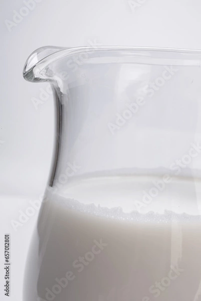 Fototapeta fresh milk in glass jug close-up on white background