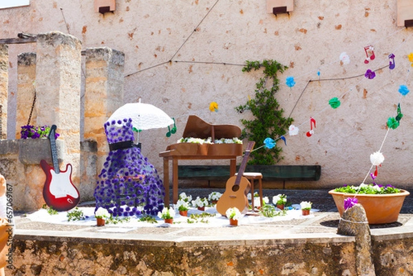Obraz Decoration, consisting of two guitars, a piano and a violet dress with some musical notes on the background, on "Costitx en Flor" (Costitx in bloom) Flower Fair, Majorca, Spain