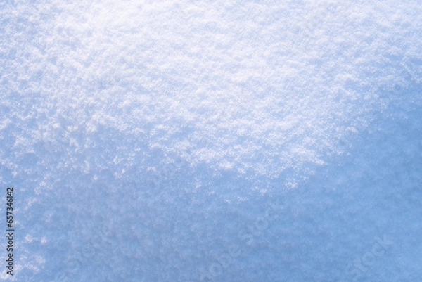 Fototapeta Beautiful light and shadow pattern. Hilly snow surface close-up in sunny day. Natural winter texture abstract background. Copy space, top view.