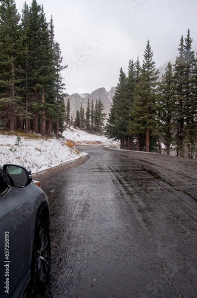 Fototapeta Car on a wet, snowy winter road in the rocky mountains of Colorado
