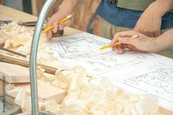 Obraz 図面を見て材木を加工する大工