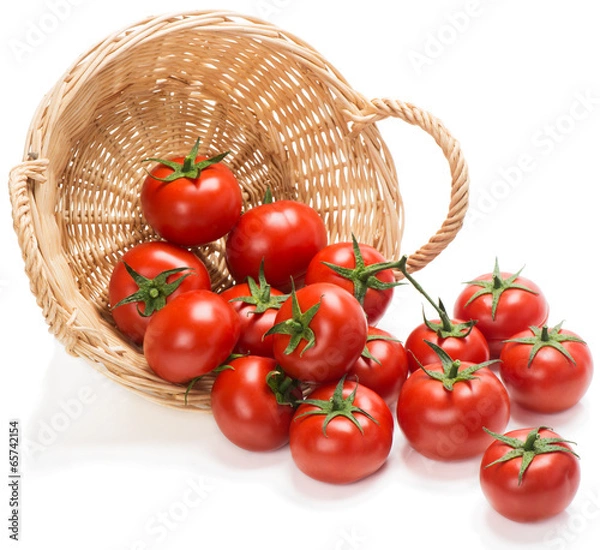 Fototapeta Tomatoes  in a basket is scattered