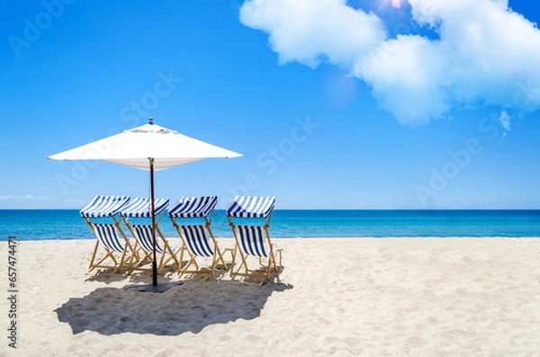Fototapeta Sunbeds and umbrella on a tropical beach