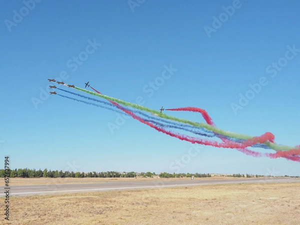 Obraz Group of fighter jet airplane with a trace of colorful smoke against sky
