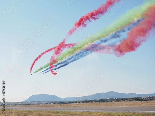 Obraz Group of fighter jet airplane with a trace of colorful smoke against sky