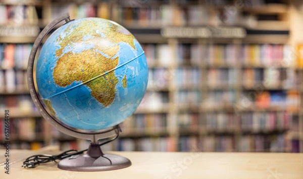 Fototapeta A globe as school equipment placed on a shelf in the school library.