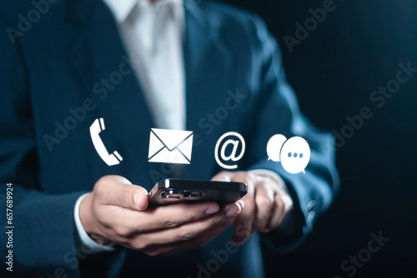 Fototapeta CONTACT US, Businessman use smartphone with contact us or Customer support hotline people connect.