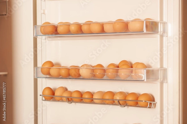 Fototapeta There are a lot of chicken eggs in the refrigerator. A source of cheap protein for food