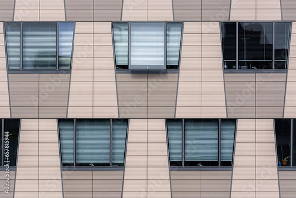 Fototapeta Beige wall of a modern building with trapezoidal windows. From the Windows of the world series.