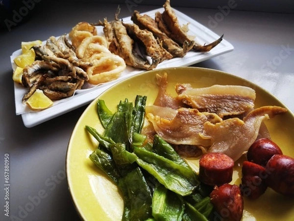 Obraz Typical Spanish food, migas, garnished with peppers, melon, fried fish, chorizos and bacon