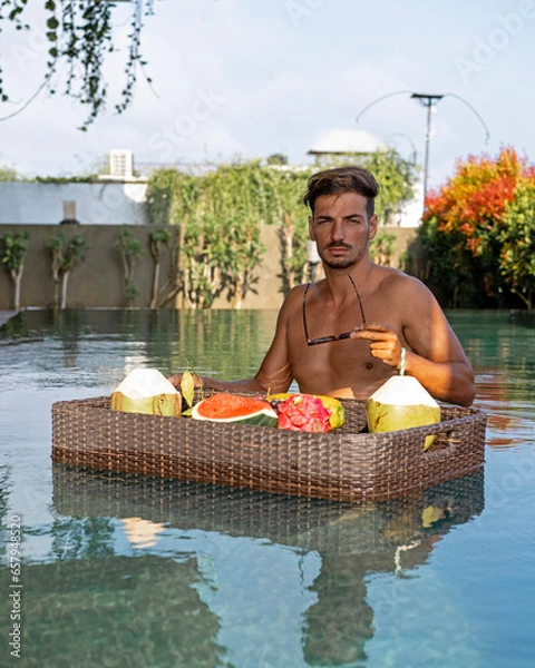 Obraz man having breakfast in the pool