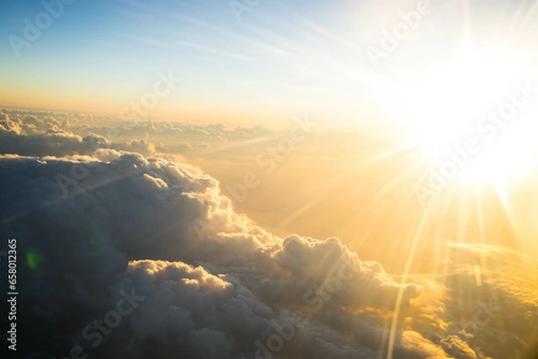 Obraz view from the airplane on orange sunset clouds