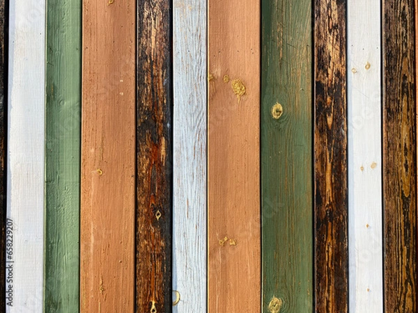 Fototapeta Colorful texture of painted in different bright colors wooden boards close up. Colorful surface of wooden wall from painted boards close-up.