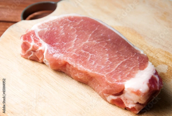 Fototapeta Raw pork on wood cutting board