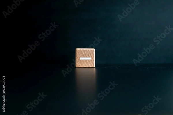 Obraz Wooden block written "-" with a black background.