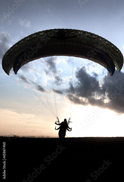Obraz paraglider silhouette at sunset