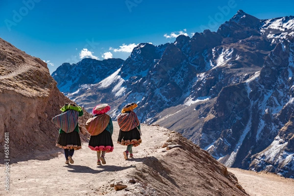 Fototapeta Peruvian vendors walking down from rainbow mountain.