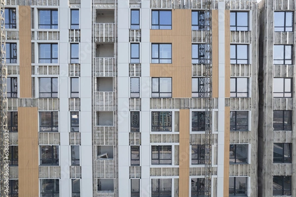 Fototapeta Facade work on a building under construction
