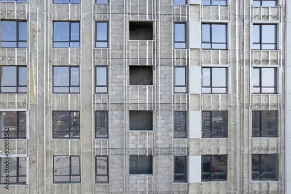 Fototapeta Facade work on a building under construction