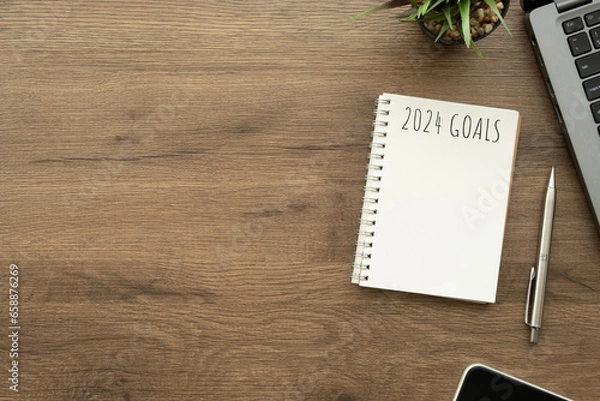 Fototapeta Notebook with 2024 goals text on it to apply new year resolutions and plan.