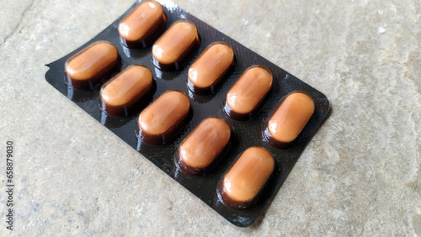 Fototapeta SOME PILLS PUT ON A STONE SURFACE