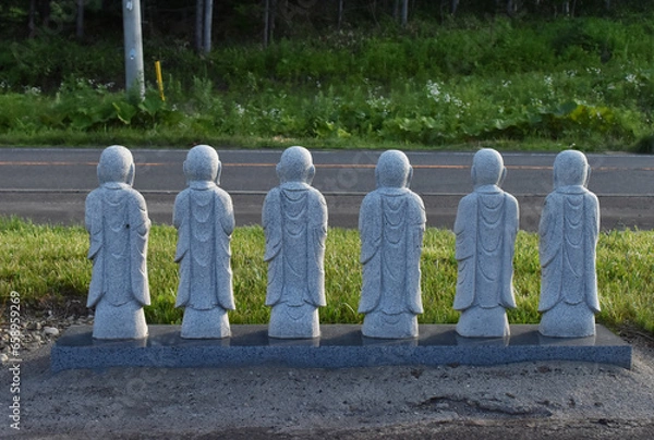 Fototapeta The small stone buddha statues showing their backs on the drive way near the Takino Reien in Sapporo Japan