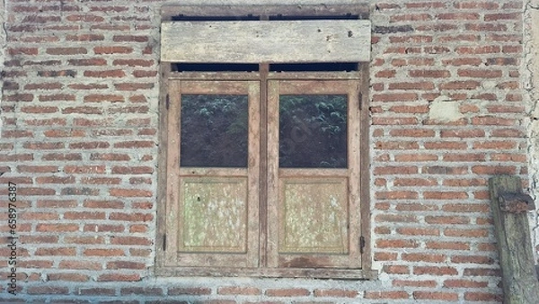 Fototapeta classic window in the middle of a brick wall