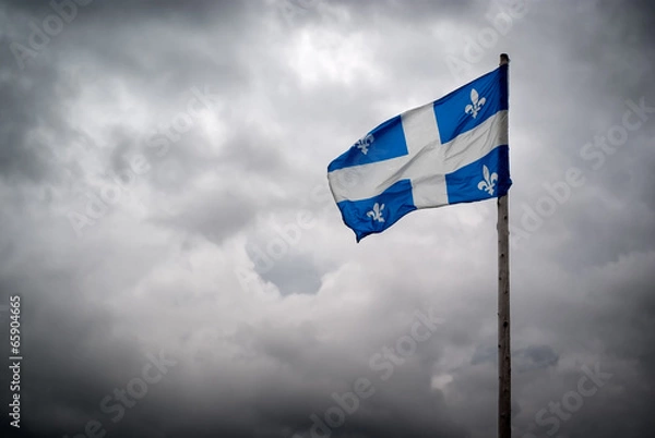 Fototapeta Quebec Flags Waves Before Stormy, Cloudy Skies