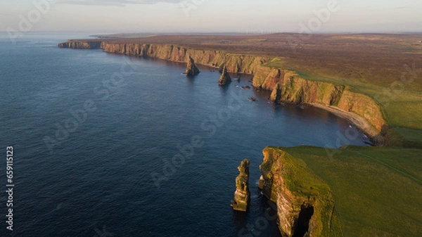Fototapeta Beautiful rock stacks and stunning landscape of Scotland. Duncansby head are lying near John o Groats and it is a northern east of United Kingdom. This place is home for seals and thousands of seagull