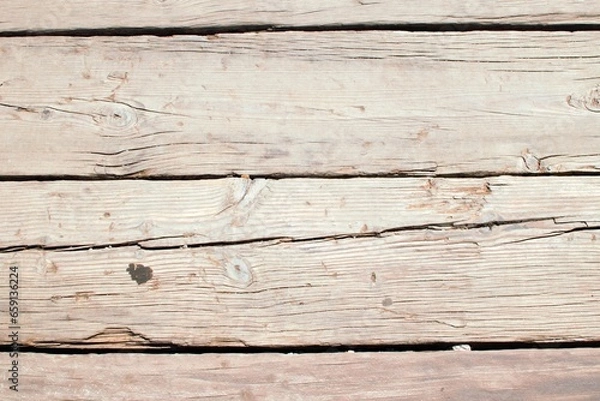 Fototapeta A collection of weathered and worn wooden boards, showcasing the character and history etched into their grain through years of use and exposure to the elements.