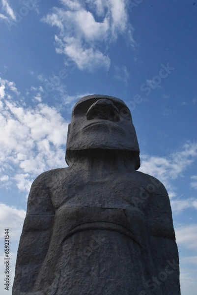 Fototapeta Sapporo Japan October 1 2023 The gorgeous huge stone Moai statue with the clear blue sky at the Takino Reien Makomanai