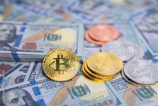 Fototapeta Verities of symbolic coin Bitcoin on mock up one hundred dollars banknotes. Exchange bitcoin cash for a dollars. Cryptocurrency on US dollar bills. Digital modern method of payment.