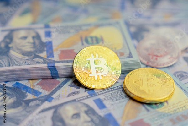 Fototapeta Golden mockup coin Bitcoin infant of mock up one hundred dollars banknotes. Exchange bitcoin cash for a dollars. Cryptocurrency on US dollar bills. Digital modern method of payment.