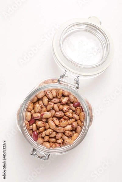 Fototapeta beans borlotti in a glass jar taken from above on a white background