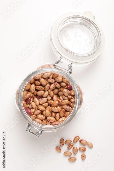 Fototapeta beans borlotti in a glass jar taken from above on a white background