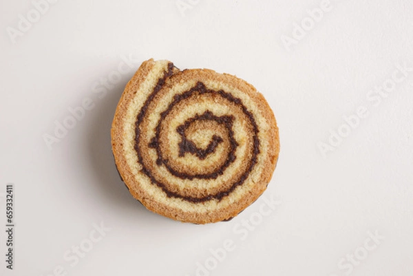 Fototapeta brioche swirl with chocolate on a white background shot from above