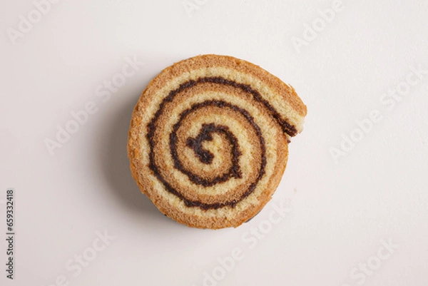 Fototapeta brioche swirl with chocolate on a white background shot from above