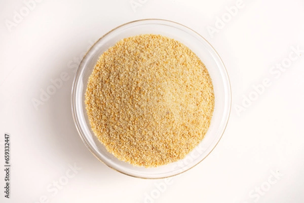 Fototapeta breadcrumbs in glass bowl on white background shot from above