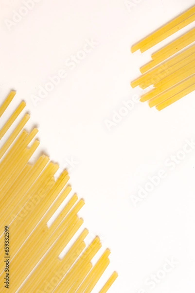 Fototapeta durum wheat spaghetti on a white background seen from above