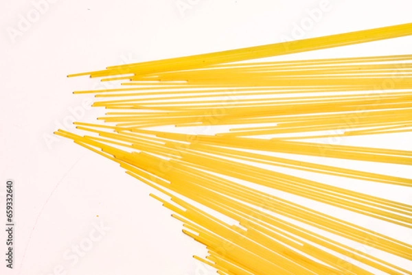 Fototapeta durum wheat spaghetti on a white background seen from above