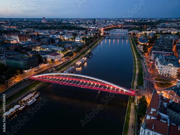 Fototapeta Krakow, Poland, aerial view of the Kazimierz and Podgorze districts with Vistula river bridges in the night