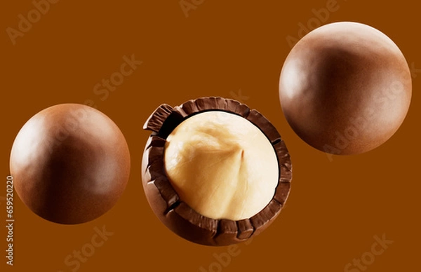Obraz Heap of  hazelnuts dragees in chocolate isolated on white background.  chocolate balls candies filled with nuts. 3d illustration. 
