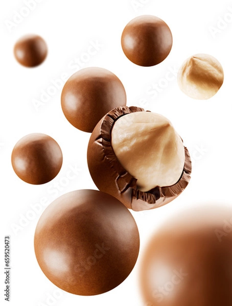 Obraz Heap of  hazelnuts dragees in chocolate isolated on white background.  chocolate balls candies filled with nuts. 3d illustration. 
