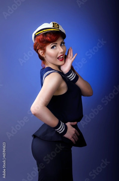 Obraz Pin up model in sailor costume isolated on blue background