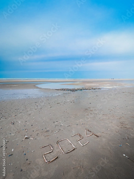 Obraz New year 2024 written with shells on a beach at low tide.
