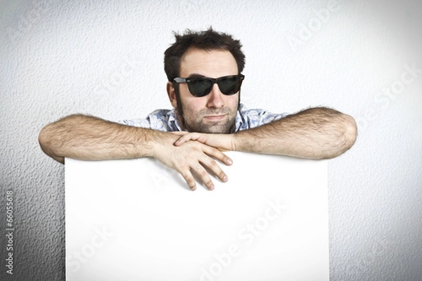 Fototapeta Happy man with sunglasses holding an empty white board
