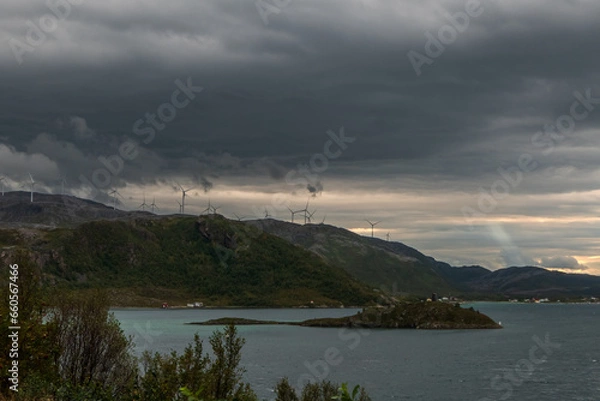 Fototapeta Several windmills on the Norwegian coastline. Dramatic clouds on the sky. Sommaroy region.